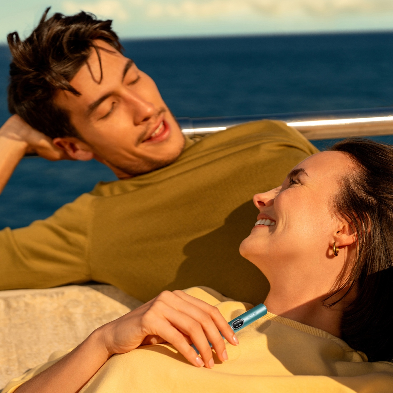 Two women looking at an IQOS device